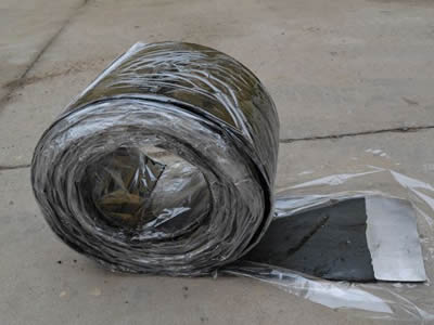 A roll of steel butyl putty rubber waterstop with plastic.