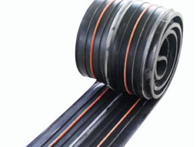 A roll of reinforced rubber waterstop with two orange swelling strips.
