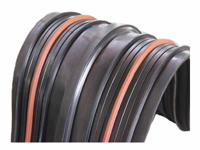 Reinforced rubber waterstop with center bulb, two orange swelling strips, four large stems and eight small stems.