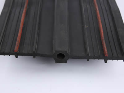 Buried reinforced rubber waterstop with six large stems, eight small stems and round bulb linked two projections.